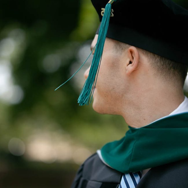 A close up photo of a graduate's cap and gown with the tassel showing - UNC Chapel Hill Graduation Photo Session