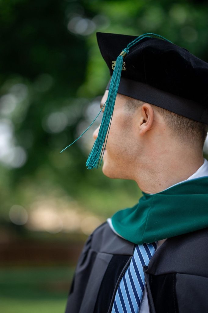 A close up photo of a graduate's cap and gown with the tassel showing - UNC Chapel Hill Graduation Photo Session