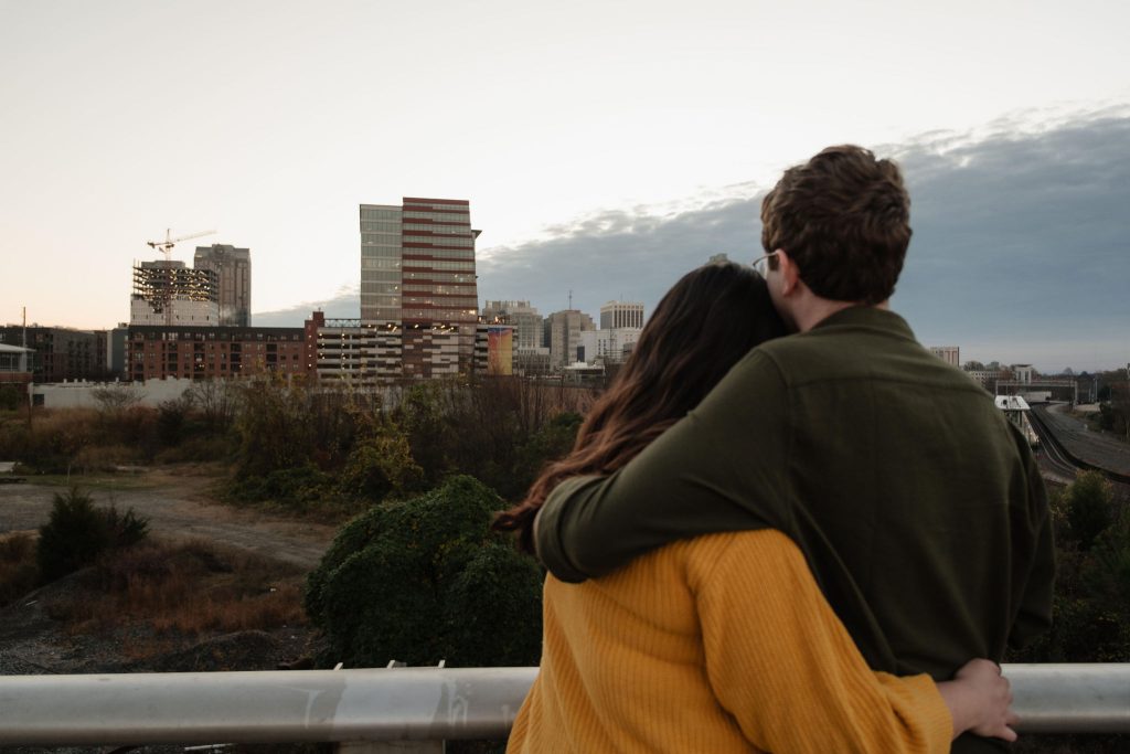 Couple looking at Downtown Raleigh near the Union Station - Downtown Raleigh NC Engagement Session