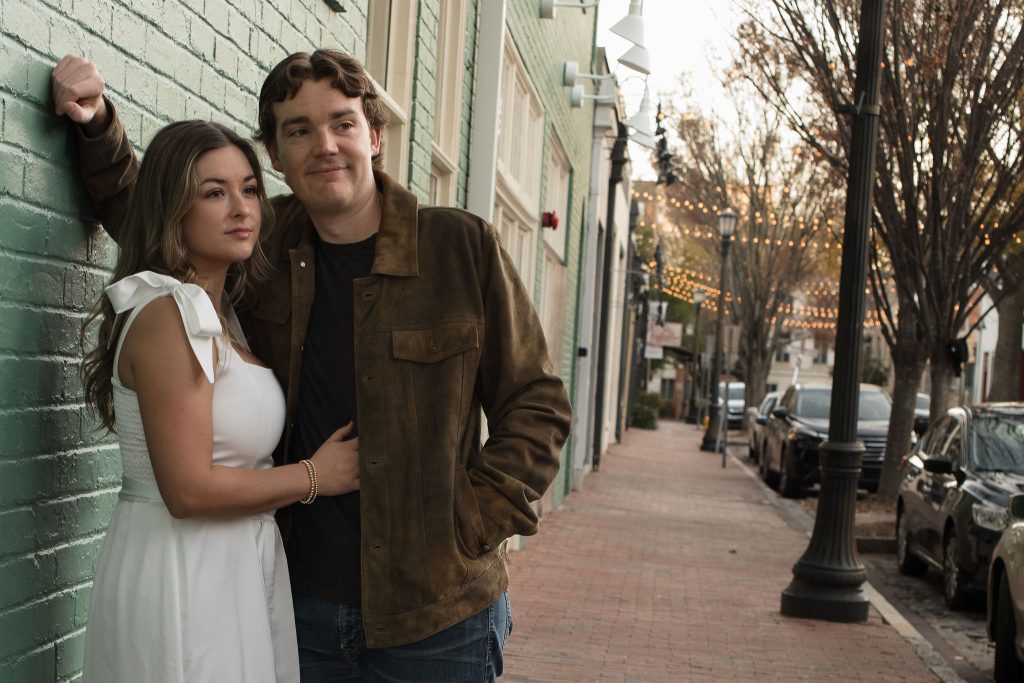 Couple looking off into the distance in City Market Downtown Raleigh NC - Engagement Session Amelia and Matt Photo
