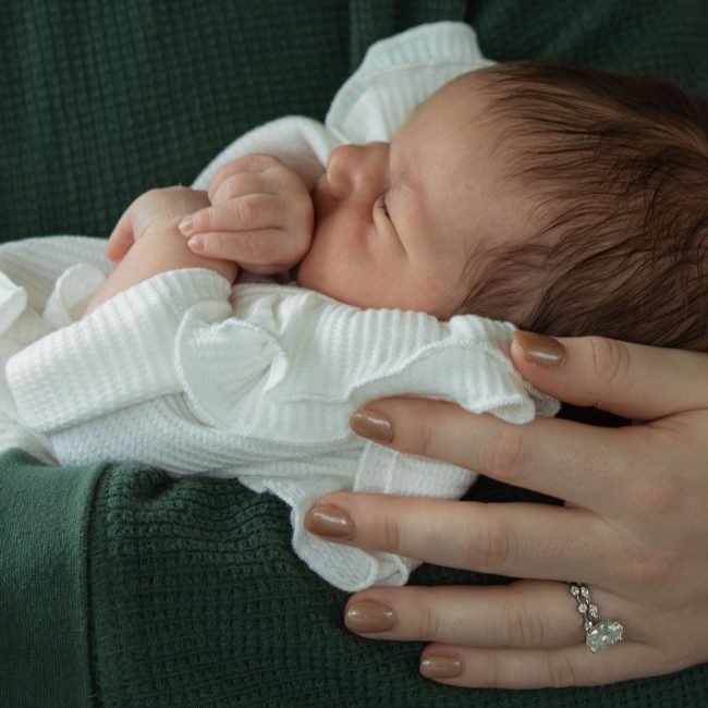 Newborn Baby in parents hands - Mebane North Caroline Newborn Photography Session