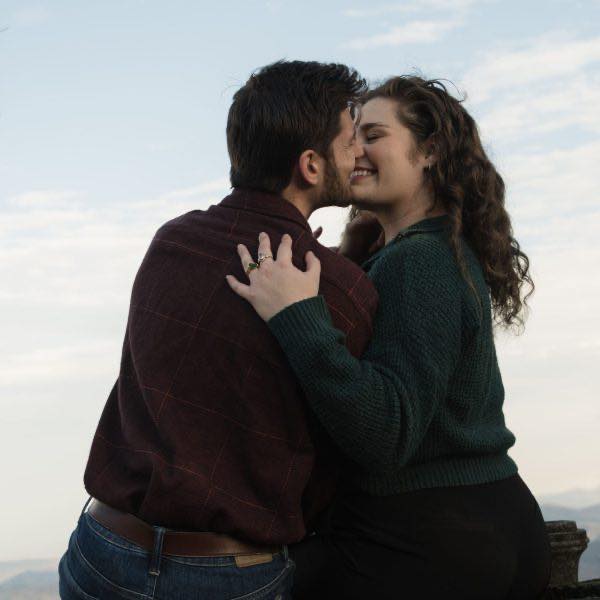 A photograph of a couple about to go in for a kiss during a couples photo session in Raleigh NC