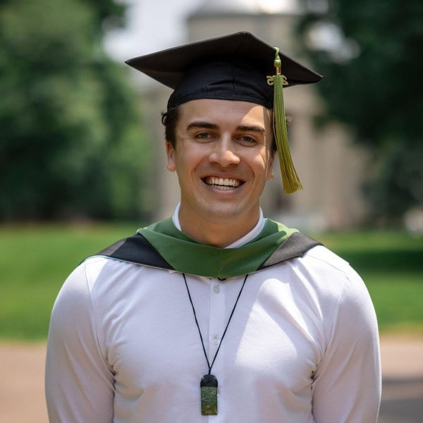 a UNC Chapel Hill student smiling while having their portrait taken during a graduation photoshoot in Chapel Hill NC