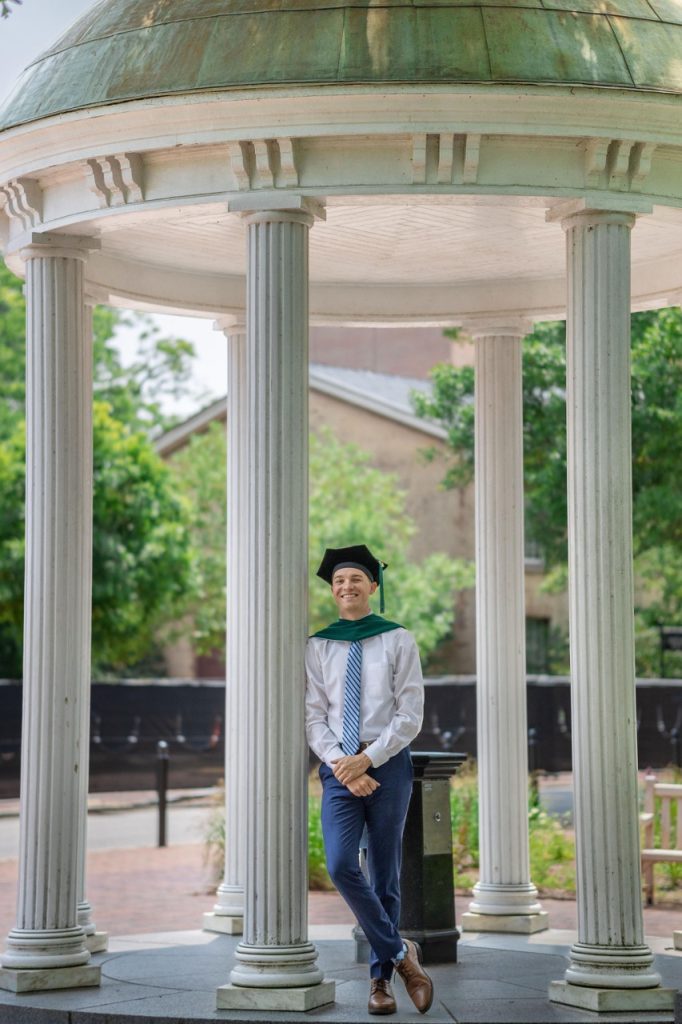 UNC Chapel Hill Student Posing in front of the old well in his graduation photoshoot