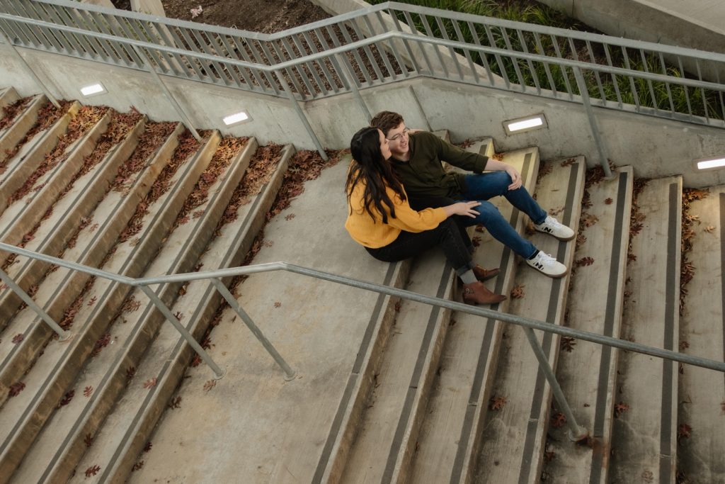 A couple sitting on stairs new Union Station in downtown Raleigh NC