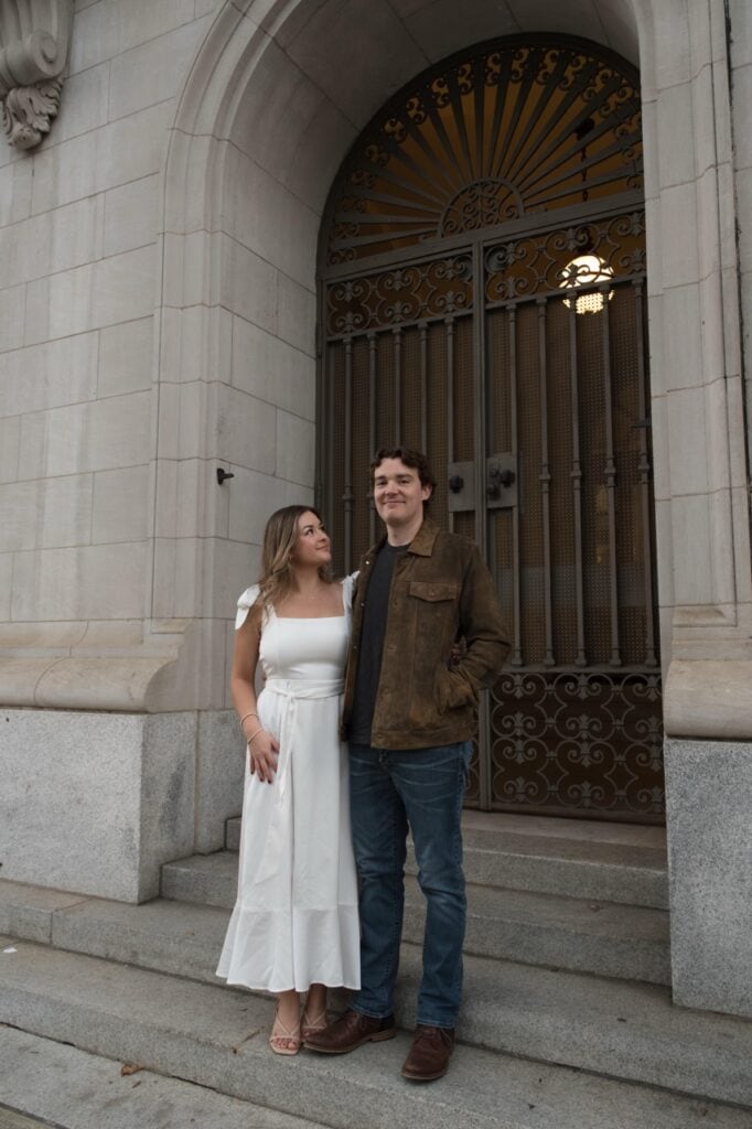 Couple posed for an engagement session at a hidden gem location in downtown Raleigh, the post office with marble stone and upscale views.