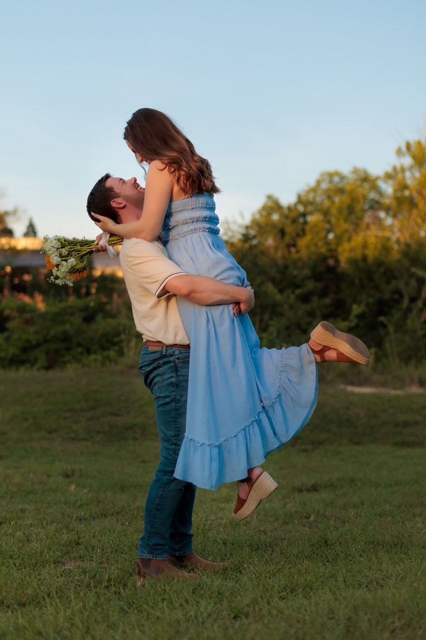 man lifting his wife and looking into her eyes