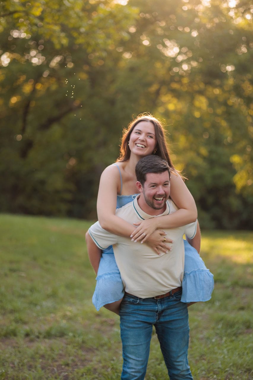 girl on her husbands back in a piggy back ride during a couples photoshoot