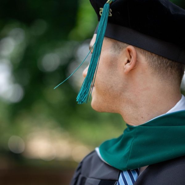 A close up photo of a graduate's cap and gown with the tassel showing - UNC Chapel Hill Graduation Photo Session