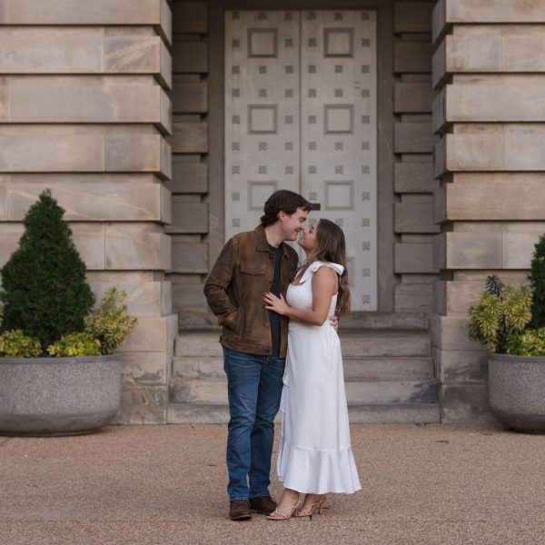 Couple kissing on the state capital in downtown Raleigh - Engagement Session