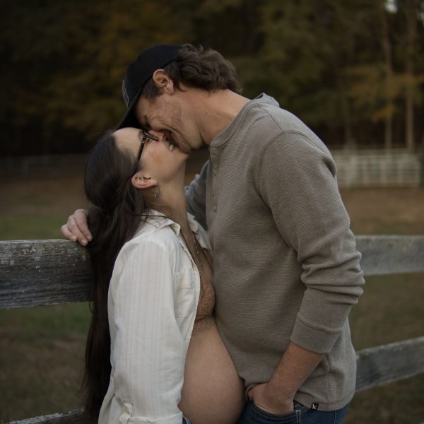 Couple kissing while on a farm in Durham NC - Maternity Photo Session Amelia and Matt Photo